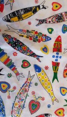 White fabric with Portuguese patterned fish motifs.